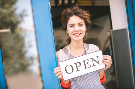 You are welcome. Cheerful young woman keeping smile on her face while being ready to work
