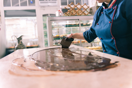 Experienced chef. Hard-working inspired experienced chef making dark chocolate in the kitchenの写真素材