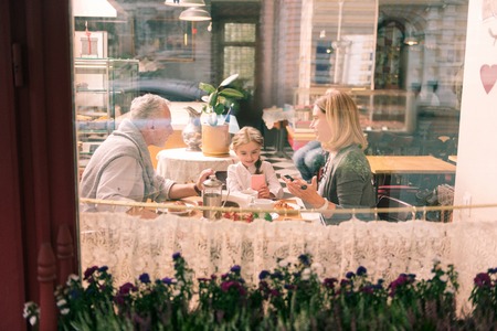 Birthday girl. Happy loving grandparents taking their birthday girl to the atmospheric French bakeryの写真素材