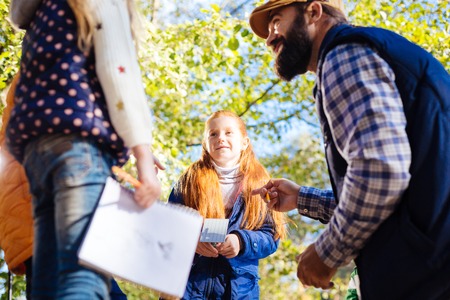 Pleasant interaction. Joyful nice children interacting with each other while having a class outdoorsの写真素材