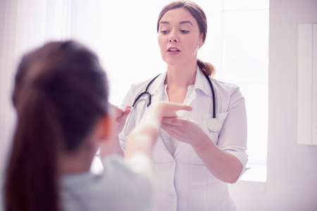 Examining health. Professional experienced general practitioner examining health of little girlの写真素材