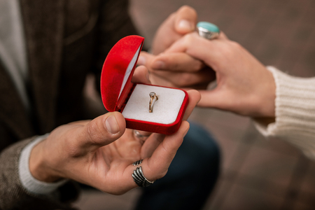 Beautiful ring. A woman receiving a ring during receiving a proposalの写真素材