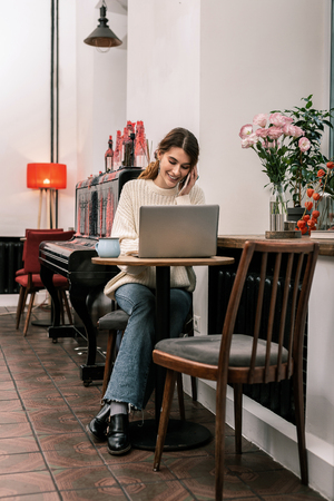 Remote job. The woman feels comfortable while working remotely from a cafeの写真素材