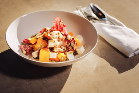 Meat and fruit. Top view of bowl with meat and fruit salad standing on the table in fancy restaurantの写真素材