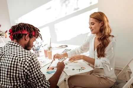 Using watercolors. Couple of talented inspired art students drawing while using watercolorsの写真素材