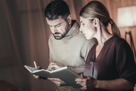 Useful information. Professional two colleagues collaborating and looking at notesの写真素材