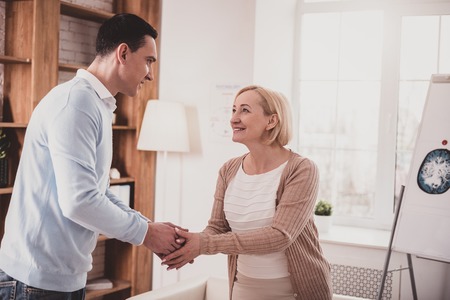 You are welcome. Delighted female person expressing positivity while communicating with her patientの写真素材