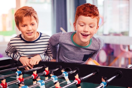 Want to see. Two children glazing being ready for the game, placing their artificial playersの写真素材