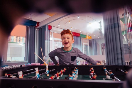Favorite interaction. Happy kid expressing positivity while visiting playing center
