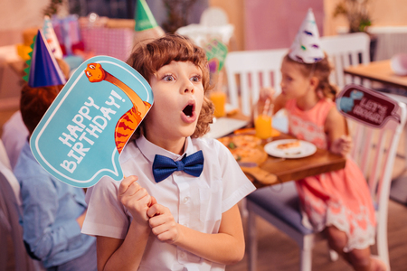 Having shock. Silhouette of charming girl that sitting at the table and drinking juiceの写真素材