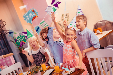 Follow us. Group of classmates having fun while being in kids cafeの写真素材