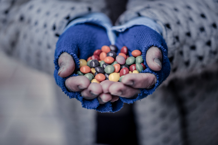 Colourful candies. Close up of a handful of colourful sweets being shown to youの写真素材