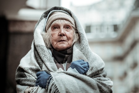 Feeling cold. Portrait of a cheerless aged woman while feeling coldの写真素材
