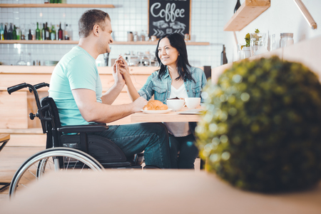 Afternoon coffee. Happy relaxed couple spending an afternoon together and drinking coffeeの写真素材