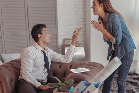 Active discussion. Enthusiastic emotional freelancers expressing bright ideas while gesticulating and showing interestの写真素材