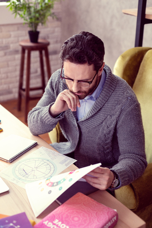 Mathematic calculation. Top view of a professional astrologist doing mathematic calculations while being at workの写真素材