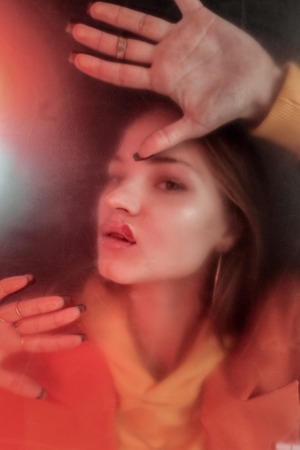 Express negativity. Young female person posing on camera and looking forward at photographer