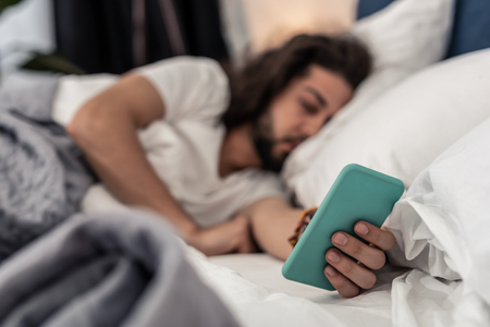 Modern gadget. Selective focus of a smartphone being in male handsの写真素材