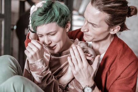 Feeling overemotional. Green-haired girlfriend feeling overemotional after big conflict with her belovedの写真素材