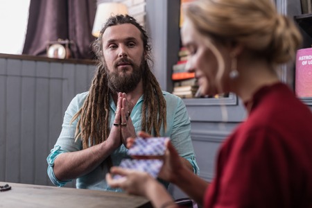 Magic energy. Nice good looking man putting his hands together while having a fortune telling sessionの写真素材