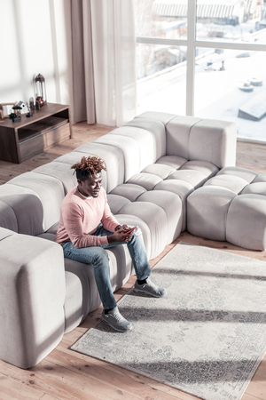 Modern technologies. Kind freelancer expressing positivity while reading messageの写真素材