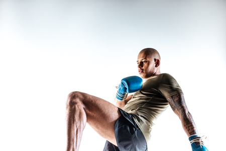Mixfighting. A man doing fighting movements with arms and legsの写真素材