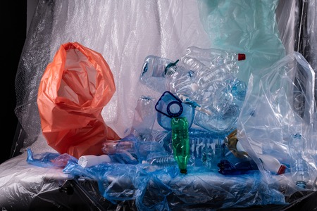 Colors and textures. Unpleasant installation with used water bottles and bags and litters showed on...