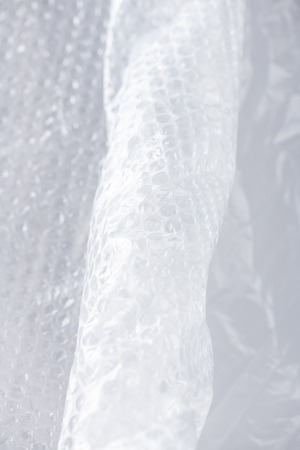 Global pollution . Crumpled and folded wrapping piece of plastic with pimples being in need for...
