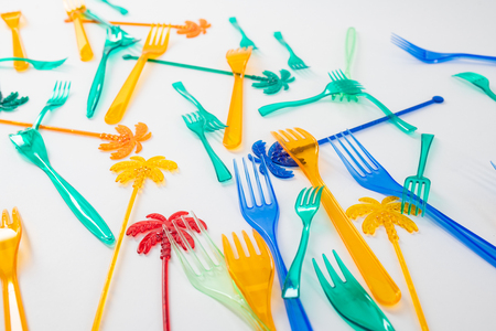 Overloading oceans. Colorful dangerous plastic utensils killing animals in the oceans and harming our environmentの写真素材