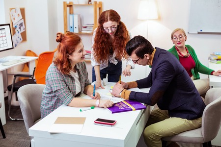 Module test. Joyful smart people doing their task while writing a module testの写真素材