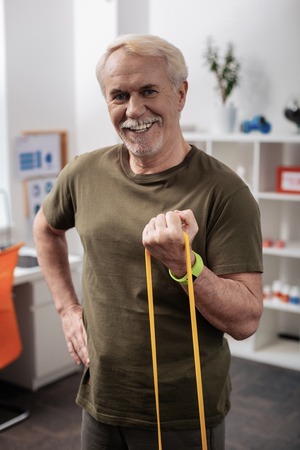Full of energy. Positive active man smiling to you while feeling full of energyの写真素材