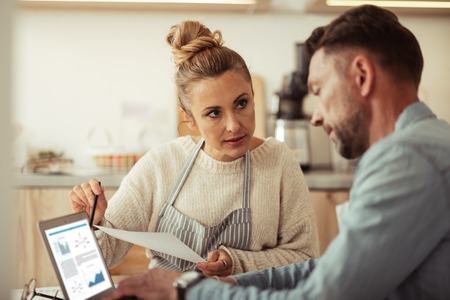 Solving problems. Smart business woman discussing eventual problems with her partner pointing on a laptop.の写真素材