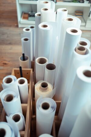 Paper rolls. Top view of paper rolls for manufacturing books standing in the wooden box