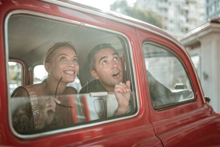Taking in the sights. Admiring husband and wifee looking at the city sightseeings out the window of...