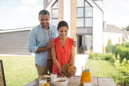 Excited before breakfast. Handsome bearded husband feeling excited before breakfast with wifeの写真素材