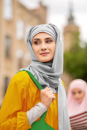 Appealing woman. Appealing young muslim woman wearing nice grey hijab standing outsideの写真素材