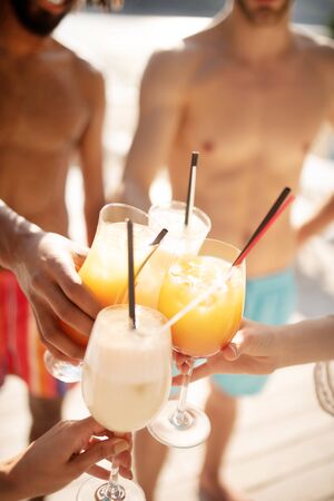 Refreshing drinks. Top view of men and women drinking refreshing drinks in hot summer dayの写真素材