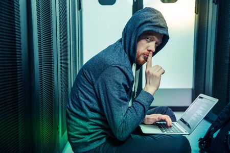 No noise. Serious bearded man telling you to be quiet while hacking into the security system