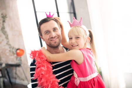 Little beaming princess. Little beaming princess wearing crown spending day with fatherの写真素材
