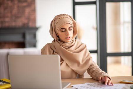 Planning time. Young Muslim girl felling puzzled while planning her weekの写真素材