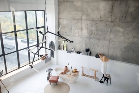 Spending perfect morning. Top view of woman spending perfect morning in bath in luxury apartmentの写真素材