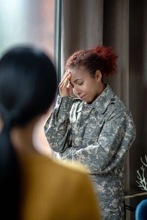 Servicewoman crying. Dark-haired servicewoman crying while remembering hard momentsの写真素材