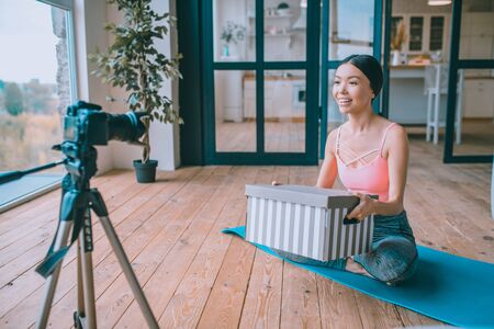 Excited before unpacking. Fitness blogger feeling excited before unpacking her fitness tools