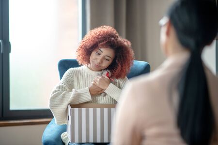Unhappy mother. Unhappy mother telling about problems with little son to psychologistの写真素材
