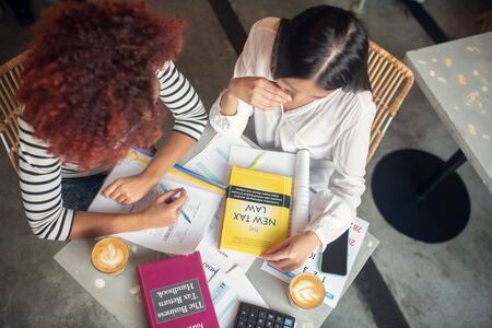 Entrepreneurs studying. Top view of two entrepreneurs studying tax law after launching businessの写真素材