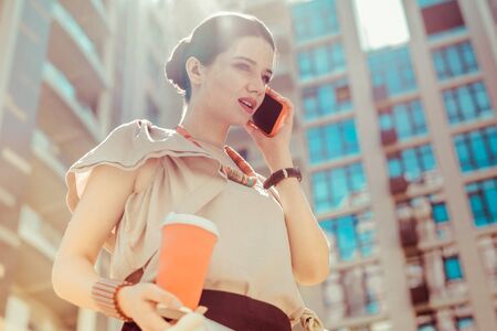 Being in all ears. Concentrated young woman being in all ears talking per telephoneの写真素材