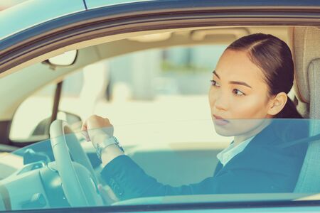 Hurry up. Attentive brunette looking at the road while being in salon of her auto