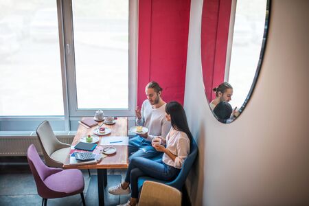 Tasting desserts. Successful entrepreneurs feeling good while tasting desserts and discussing menuの写真素材