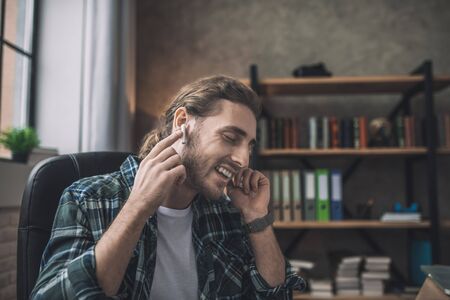 Being emotional. A man expressing his emotions while listening to the musicの写真素材