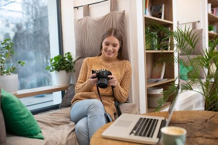 Retouching pictures. A smiling photographer editing her pictures in photoshop